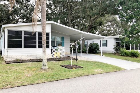 2-BR/2-BA double-wide in an ideal location at 417 Gulf Stream Drive, Lake Alfred, in Central Florida. Gray/White 1994 double-wide with turquoise shutters