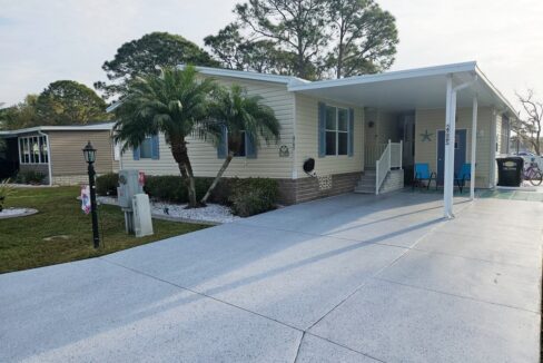 Leisure Living: Joyful Retirement Lifestyle begins owning this beautiful home at 2705 Alcott Dr, Lake Wales, FL. Cream colored vinyl siding, extra wide driveway, blue shutters
