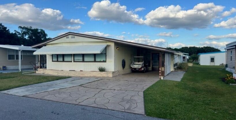 158 Palmetto Dr. Charming Abode: Exterior with awning and carport in Ridge Manor in Haines City.