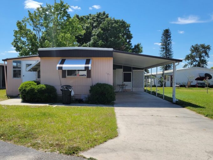 Affordable Renovated Getaway at 191 Rainbow LN W, Dundee, Florida. Single-wide home w/2 lanais and covered carport in lakefront community.