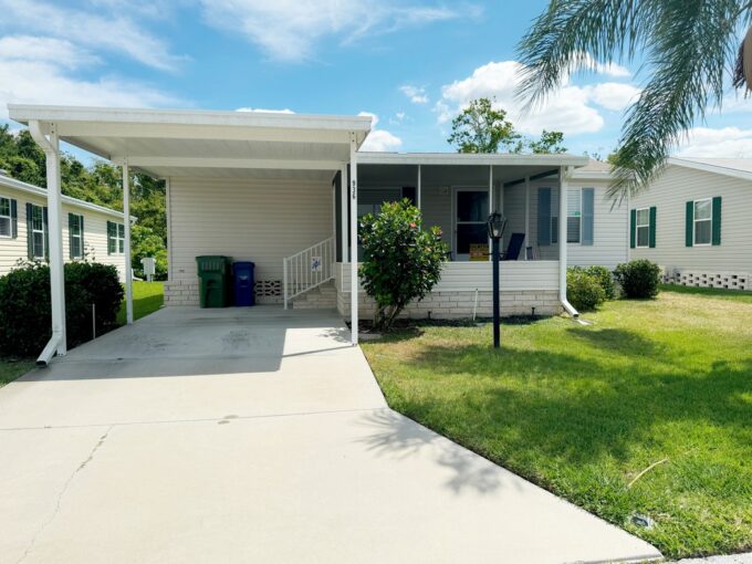 This 2014 Nobility manufactured home is modern gem located at 936 Heartwood Cypress DR in Cypress Creek Village, Winter Haven, Florida. Beige Vinyl Siding with driveway, and covered carport and screened lanai