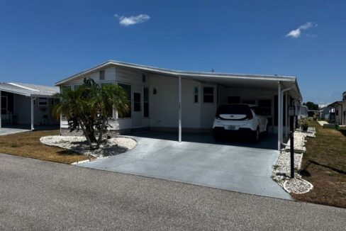 View 2 - Exterior picture with extended carport, gutters, private driveway.