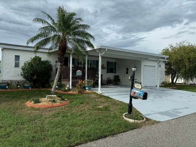 2703 Lindrick Ct in Four Lakes in Winter Haven, 1740 sq ft triple wide with golf cart garage, private driveway, gutters, curbside mail delivery.