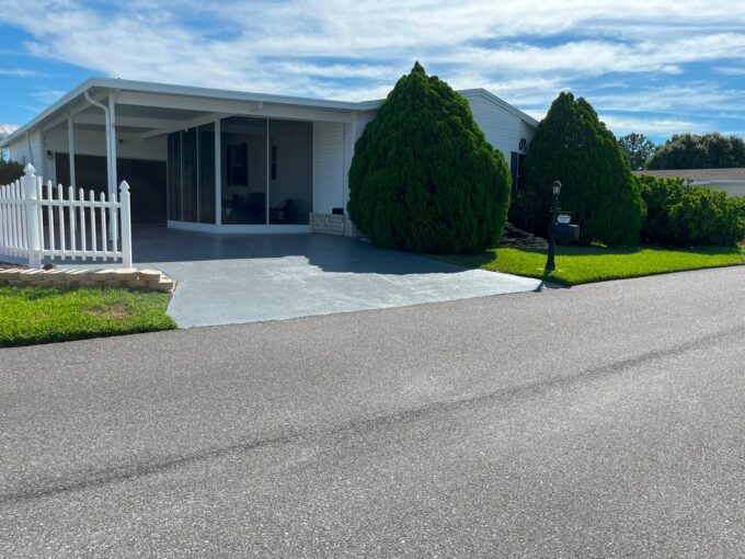 1094 LaCosta Lane W #666 located in Four Lakes Golf in Winter Haven. Homes of Merit home with white vinyl siding, with matured landscaping, private driveway, screened porch with a 1.5 car garage.