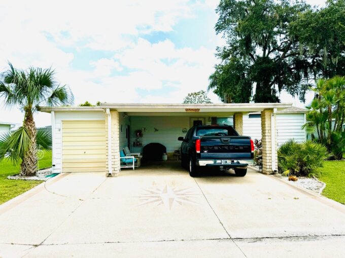 4572 Avalon Cove in Schalamar Creek in Lakeland. Double wide two bedroom two bathroom. Carport, gutters, private drive way, golf cart shed with automatic door. This home is full of potential.