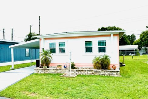 View 3 - double wide, white aluminum siding, carport, gutters, new AC, new double pane windows, updated bathroom, two walk in closets.