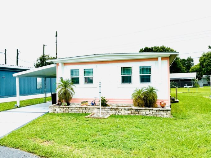 View 3 - double wide, white aluminum siding, carport, gutters, new AC, new double pane windows, updated bathroom, two walk in closets.