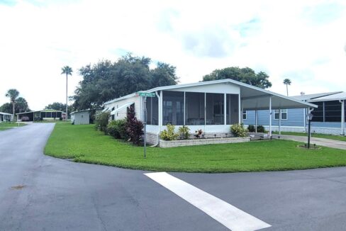 119 Lake Hazel in Orange Manor West in Winter Haven. This home sits on a corner lot, nice manicured yard, screened lanai in the front of home, carport, private driveway, curb side mail delivery, hurricane awnings.