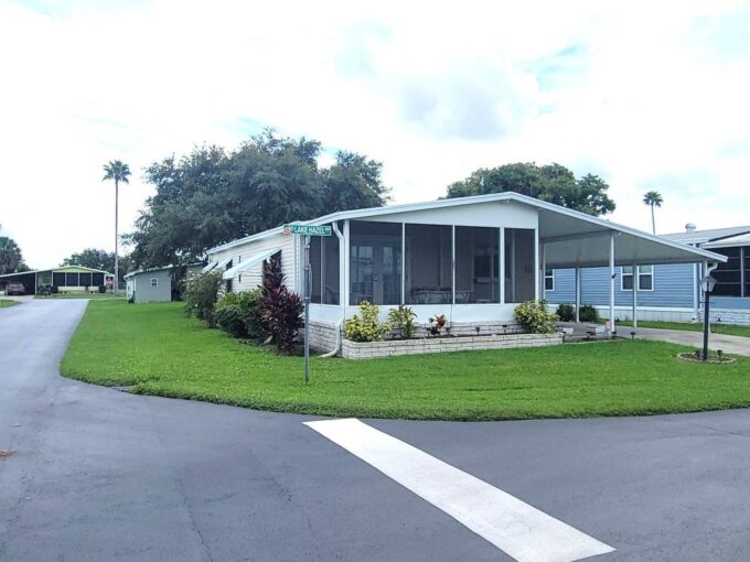 119 Lake Hazel in Orange Manor West in Winter Haven. This home sits on a corner lot, nice manicured yard, screened lanai in the front of home, carport, private driveway, curb side mail delivery, hurricane awnings.