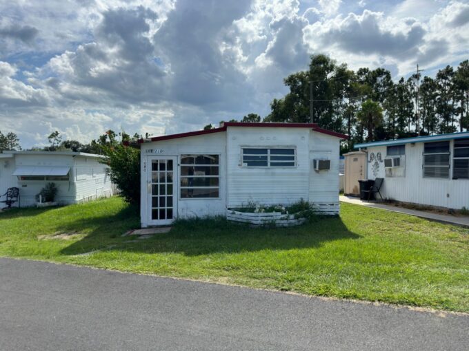 1080 Bayou Ave in Florida Camp Inn located in Davenport. This converted RV home has a neutral color palette, 2 bedrooms with 1 bathroom, split floor plan, 3 AC wall units, storage shed wired with electricity.