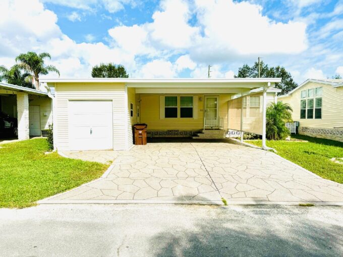 Stunning 3-Bedroom 2 bathroom Home in Schalamar Creek Golf Community in Lakeland, Florida. Storage shed, lanai, carport, private driveway, private back yard. Yellow vinyl siding.