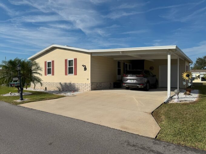 Oversized driveway carport, storage shed, lanai, two bedrooms with two bathrooms home.