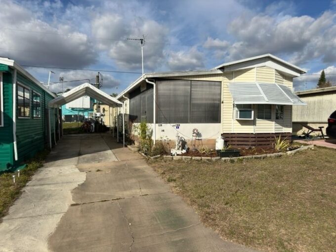 Portable carport, long private driveway, 2 storage sheds.