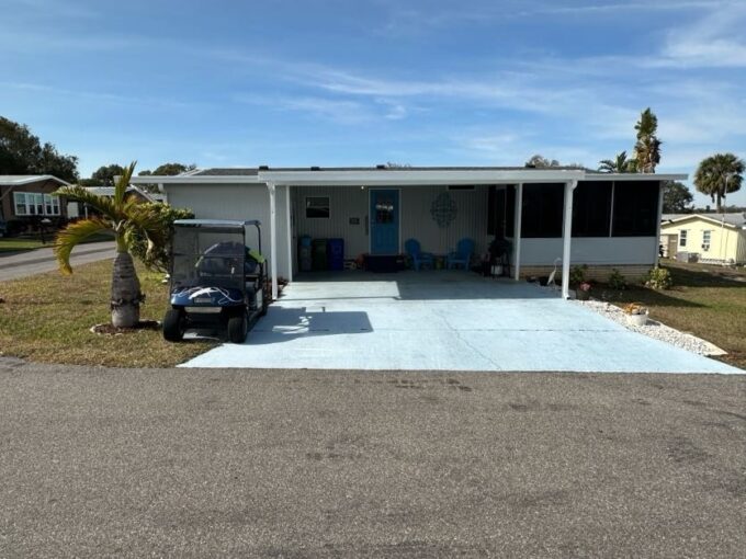 The entrance of the home is covered by the 2-car carport. Private driveway, gutters, curbside mail delivery.