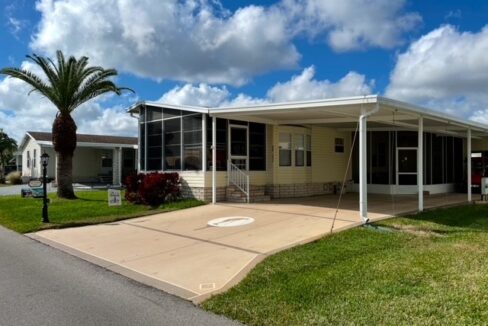 This home is being sold turnkey. Private driveway, carport, gutters, front lanai plus a screened lanai under carport. Storage shed is large enough to store golf cart that is included in sale. Golf course community.