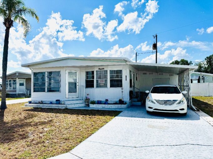 Discover the perfect blend of comfort and convenience in this beautifully maintained two-bedroom, two-bath home. When you drive up you will notice the 4-season porch on the front of the home. Unwind in this comfy space surrounded by vinyl windows for a seamless blend of indoor comfort and outdoor views. t’s sure to be your favorite spot to enjoy Florida’s beautiful weather without bugs or sunburn! Open all the windows and enjoy the breeze through the screens when the weather is perfect or enjoy climate-controlled temperatures when it’s too warm or chilly.