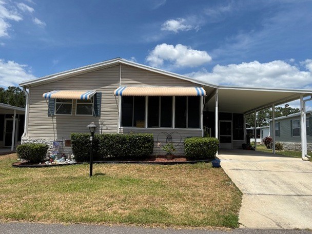 This 2 BR, 2 BA home plus a finished lanai that looks like a cozy den is ready and waiting for you. Partially furnished, private driveway, carport, awnings, storage shed, screened porch, lanai all in a gated community.