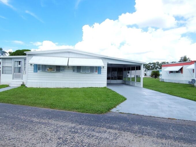 Corner lot, private driveway, lanai, screened rooms, storage shed, gutters, metal roof, awnings.