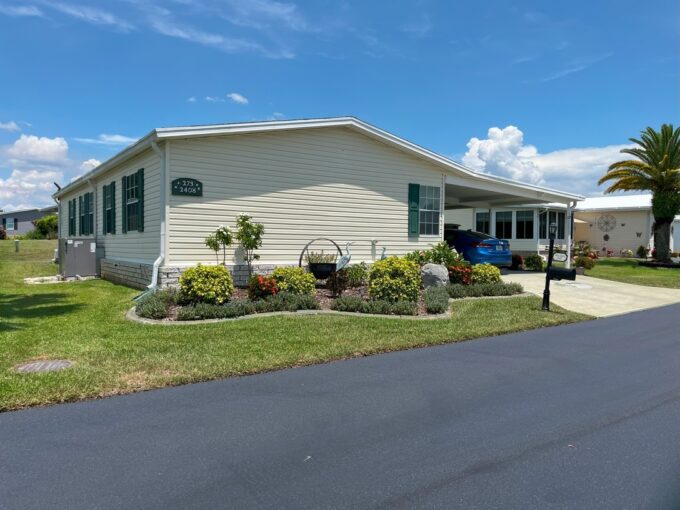 Beautifully Maintained Home offers an Inviting and Spacious Layout. Nice landscaping, private driveway, carport, lanai at the back of home. golf cart garage and golf cart included in sale.