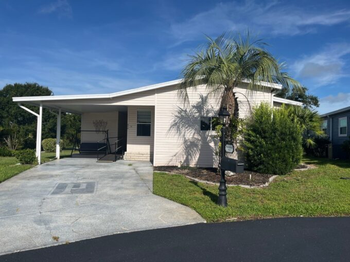 This home is on a cul-de-sac, private driveway, carport, wheelchair ramp, golf cart garage, lanai and on the golf course.