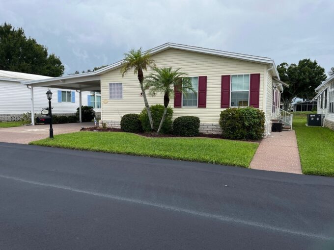 This thoughtfully designed residence seamlessly blends comfort with entertainment space. Begin each day in the air-conditioned, glass enclosed lanai, where you can savor your morning coffee while watching the golfers perfect their swing! Private driveway, carport, golf cart garage, 4 season room plus it comes furnished.