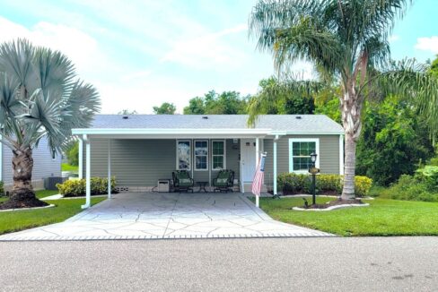 Great location in the community, private deco driveway, carport, sage green home with 2 bedrooms and 2 full bathrooms. Mature landscaping.