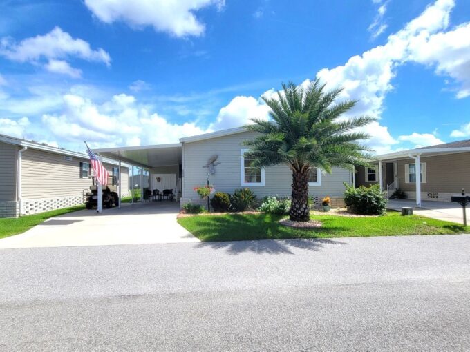 Private driveway, nice landscaping around home, extra golf cart pad, golf cart garage, lanai.