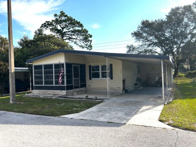 2 bedroom with 2 bathroom home with private driveway, carport, front lanai, storage shed. Mature trees around to provide shade.