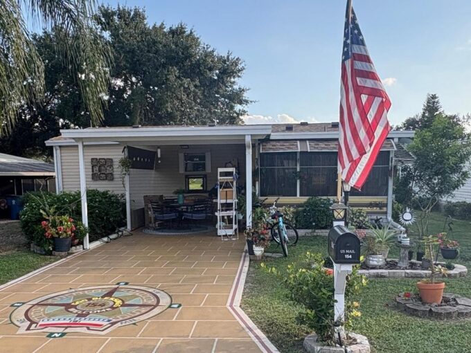 This home has a decorated driveway, carport, lanai, storage shed, 2 bedrooms, 2 bathrooms, walk in closets, kitchen with an island and pantry. Being sold fully furnished.