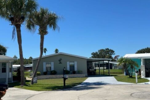 beautiful sprawling ranch style home with 3 bedrooms, 2 bathrooms, approximately 1500 square feet fully furnished, renovated eat-in kitchen has all new soft close cabinets & drawers, counter tops, a large formal dining room, spacious living room with water view, open concept with a split bedroom design floor plan, expansive owners suite and an ensuite with double sink vanity, interior laundry room, wrap-around 480 square feet Lanai with stamped deco concrete floor, 4 car deco driveway and carport, golf cart, storage shed, side yard wrap around sidewalk, beautiful landscaping with exterior up lighting at night, newly painted interior and exterior with updated crown molding, located on a cul-de-sac.