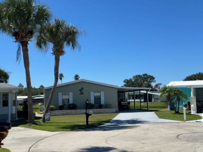 beautiful sprawling ranch style home with 3 bedrooms, 2 bathrooms, approximately 1500 square feet fully furnished, renovated eat-in kitchen has all new soft close cabinets & drawers, counter tops, a large formal dining room, spacious living room with water view, open concept with a split bedroom design floor plan, expansive owners suite and an ensuite with double sink vanity, interior laundry room, wrap-around 480 square feet Lanai with stamped deco concrete floor, 4 car deco driveway and carport, golf cart, storage shed, side yard wrap around sidewalk, beautiful landscaping with exterior up lighting at night, newly painted interior and exterior with updated crown molding, located on a cul-de-sac.